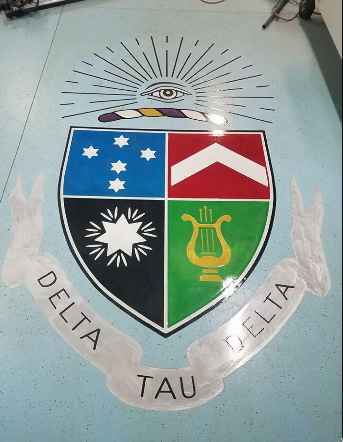 Delta Tau Delta crest engraved and hand-colored on a floor