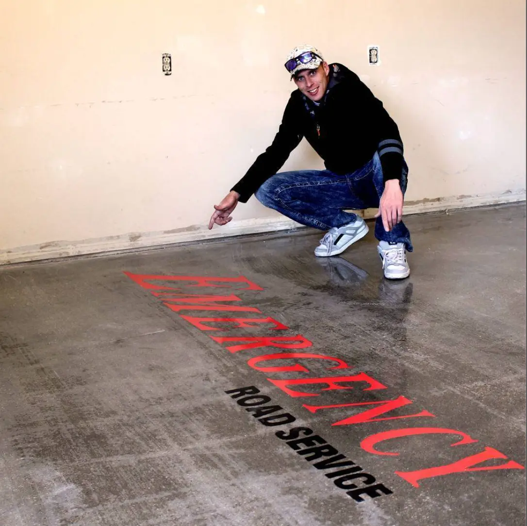 Emergency Road Service lettering engraved in red on concrete