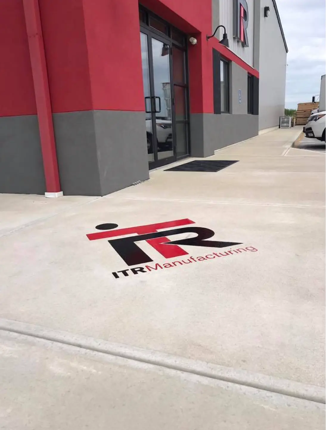 ITR Manufacturing logo engraved in a concrete entry walkway