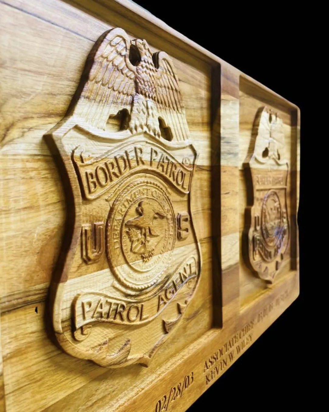 Border Patrol badge carved in relief on a wood plaque