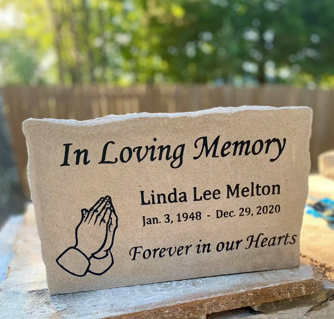 In Loving Memory engraved memorial stone with praying hands
